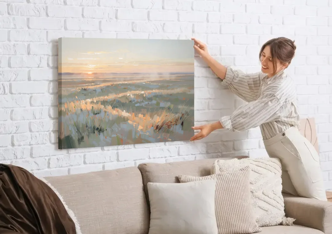 Panoramic Landscape Wall Art of Dawn Over Prairie Grass canvas wall art being hung on a white brick wall above a sofa