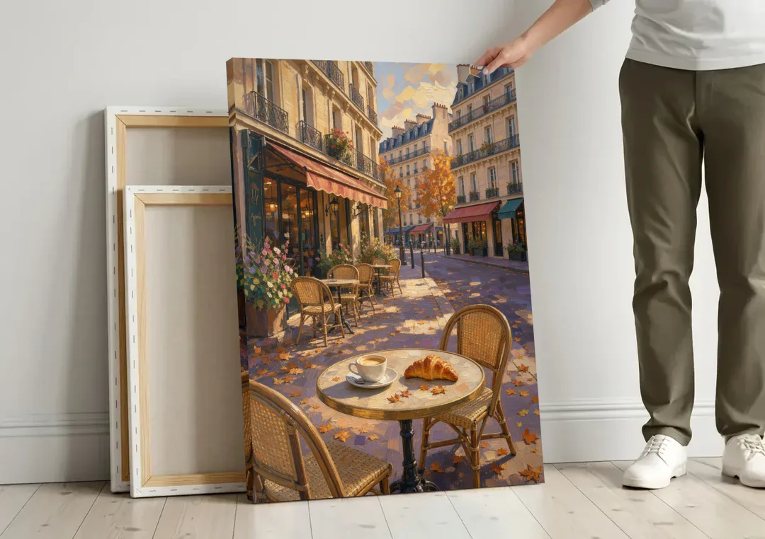 Impressionist Paris Cafe Croissant in Autumn canvas wall art leaning against a wall next to blank canvases
