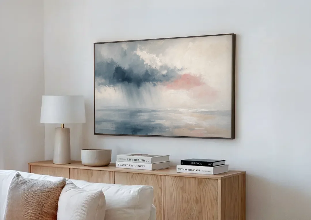 Passing Rain Over a Calm Sea Above the Headboard canvas wall art above a wooden sideboard next to a sofa