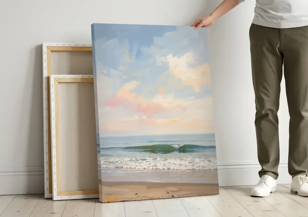 Pastel Abstract Wall Art of a Blush Morning Sea canvas wall art leaning against a wall next to blank canvases