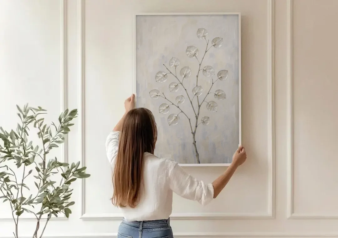 Peaceful Bedroom Art of a Silver Honesty Branch canvas wall art being hung on a paneled wall