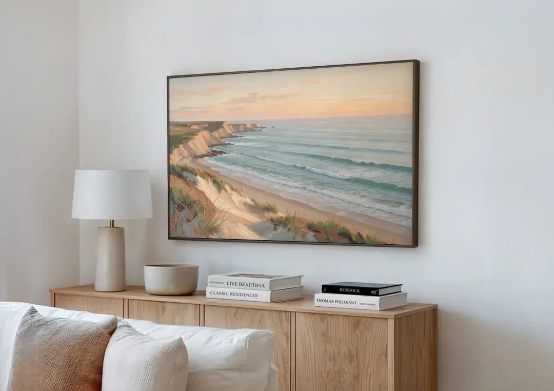 Peach Dawn Seascape Over Chalk Bluffs canvas wall art above a wooden sideboard next to a sofa