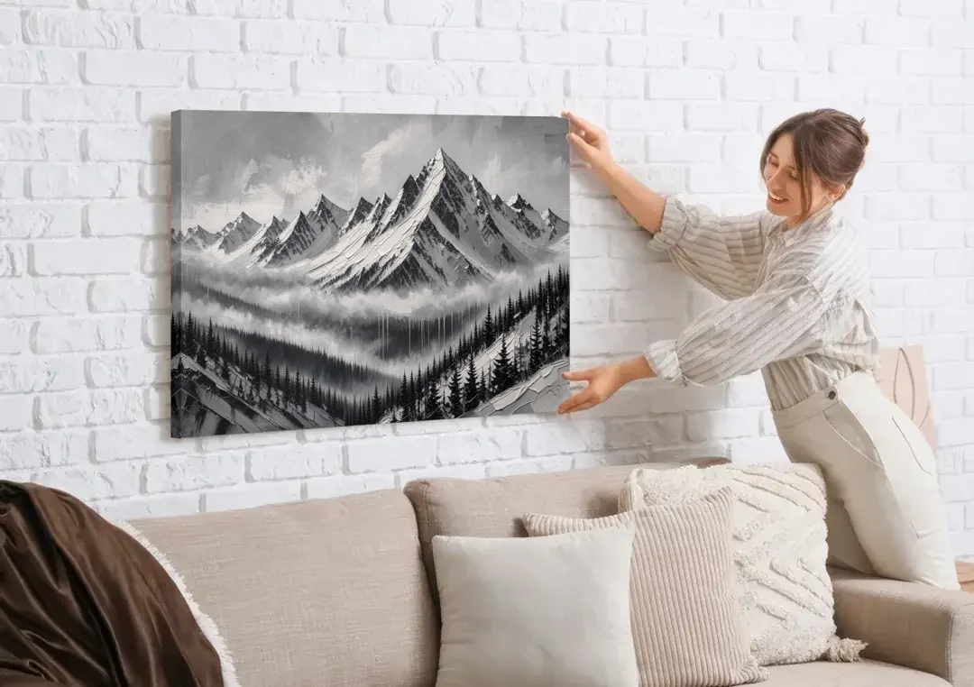 Snowy Mountain Peaks Above the Misty Firs canvas wall art being hung on a white brick wall above a sofa