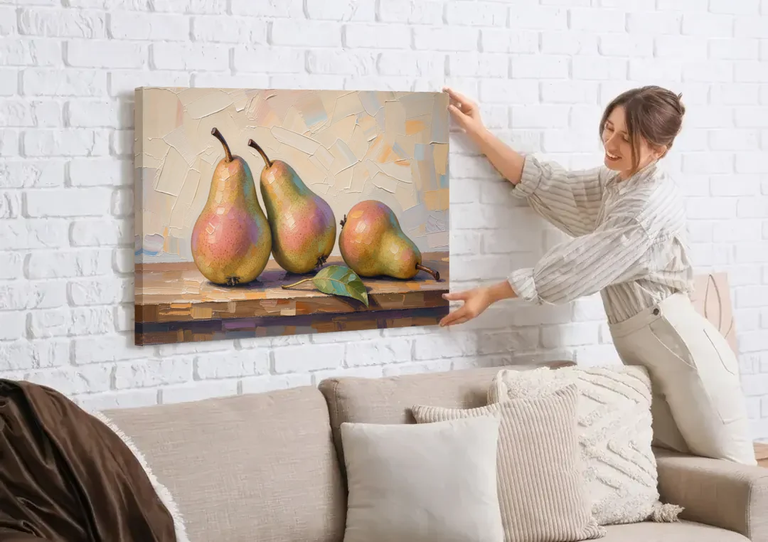 Pear Painting Trio with a Single Leaf canvas wall art being hung on a white brick wall above a sofa