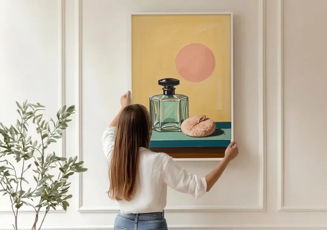 Perfume Bottle Wall Art with Powder Puff canvas wall art being hung on a paneled wall