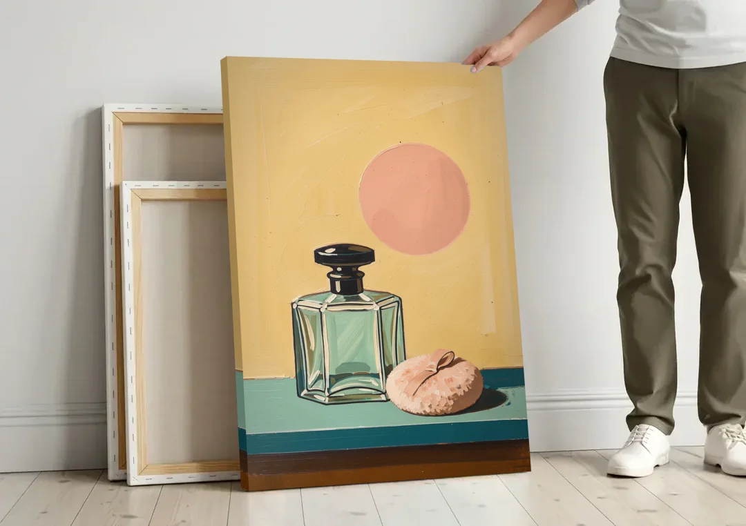 Perfume Bottle Wall Art with Powder Puff canvas wall art leaning against a wall next to blank canvases