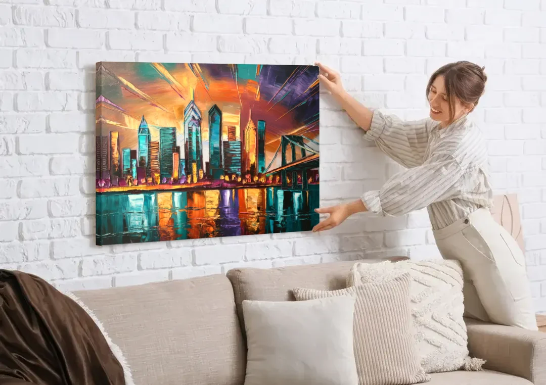 Philadelphia Mural Art canvas wall art being hung on a white brick wall above a sofa
