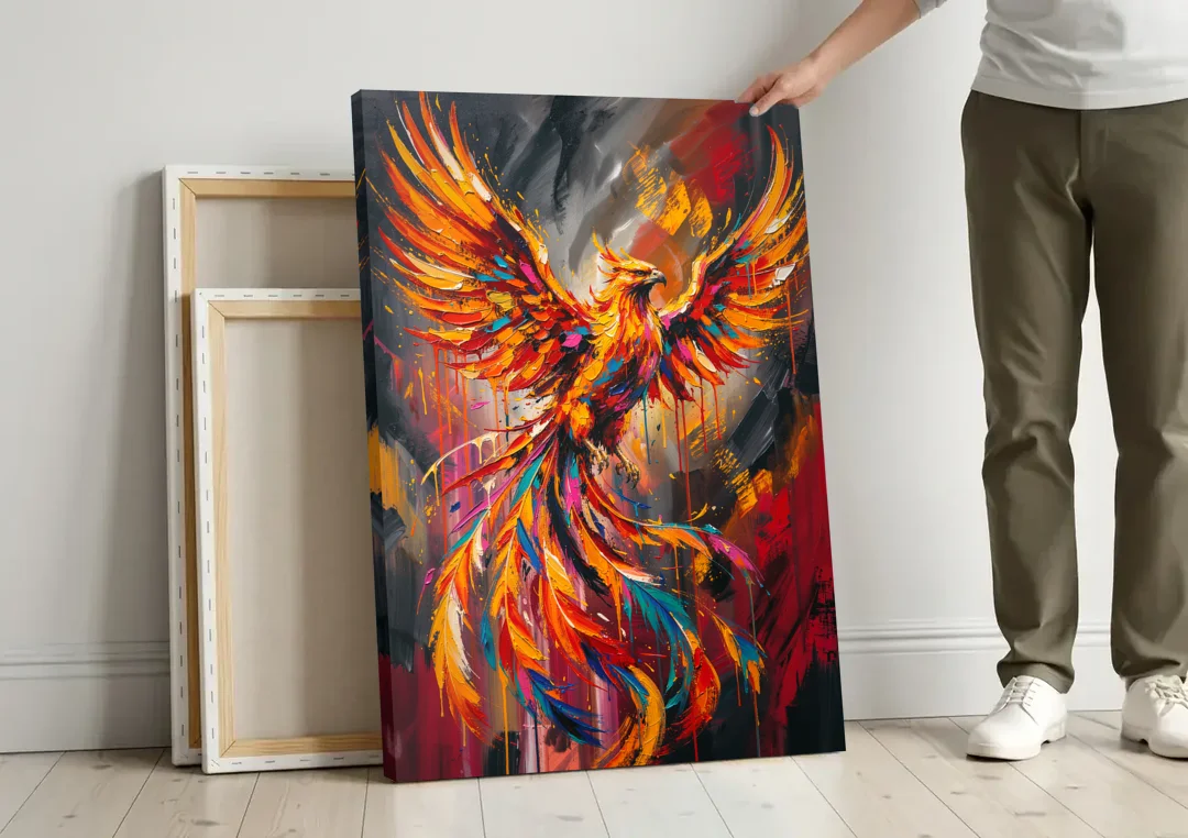 Phoenix Bird in Flight canvas wall art leaning against a wall next to blank canvases