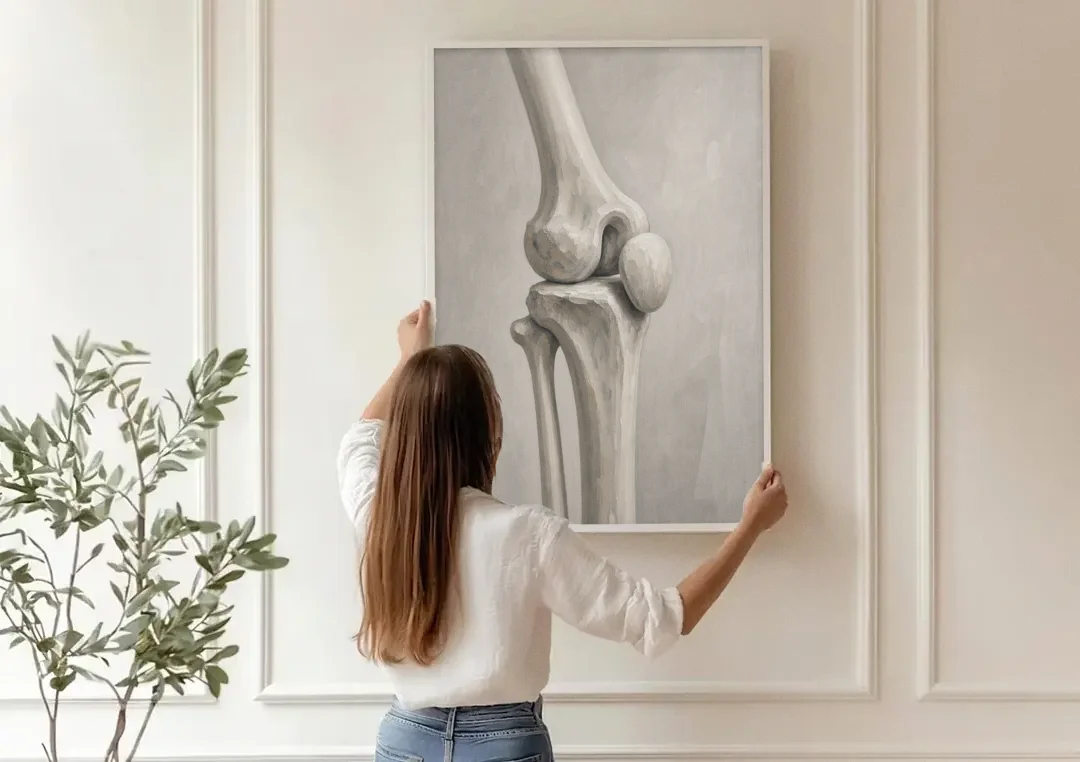 Physical Therapy Wall Art of the Knee Joint canvas wall art being hung on a paneled wall