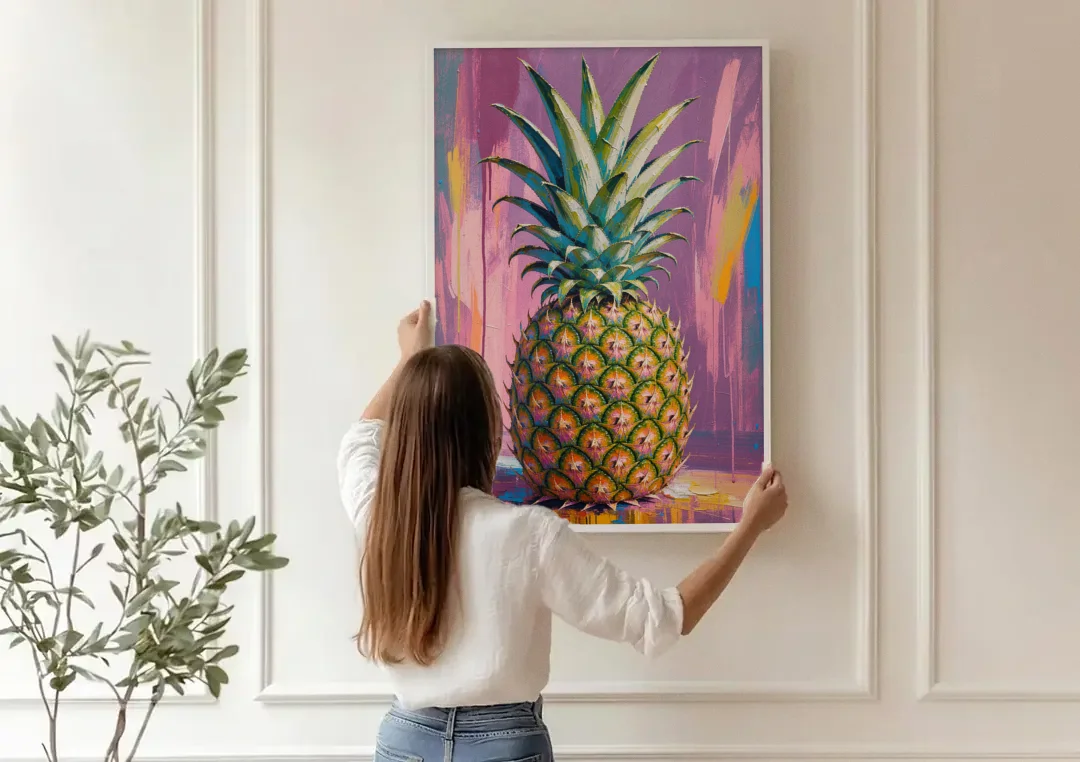 Pineapple Wall Art with a Flame Crown on Mauve canvas wall art being hung on a paneled wall