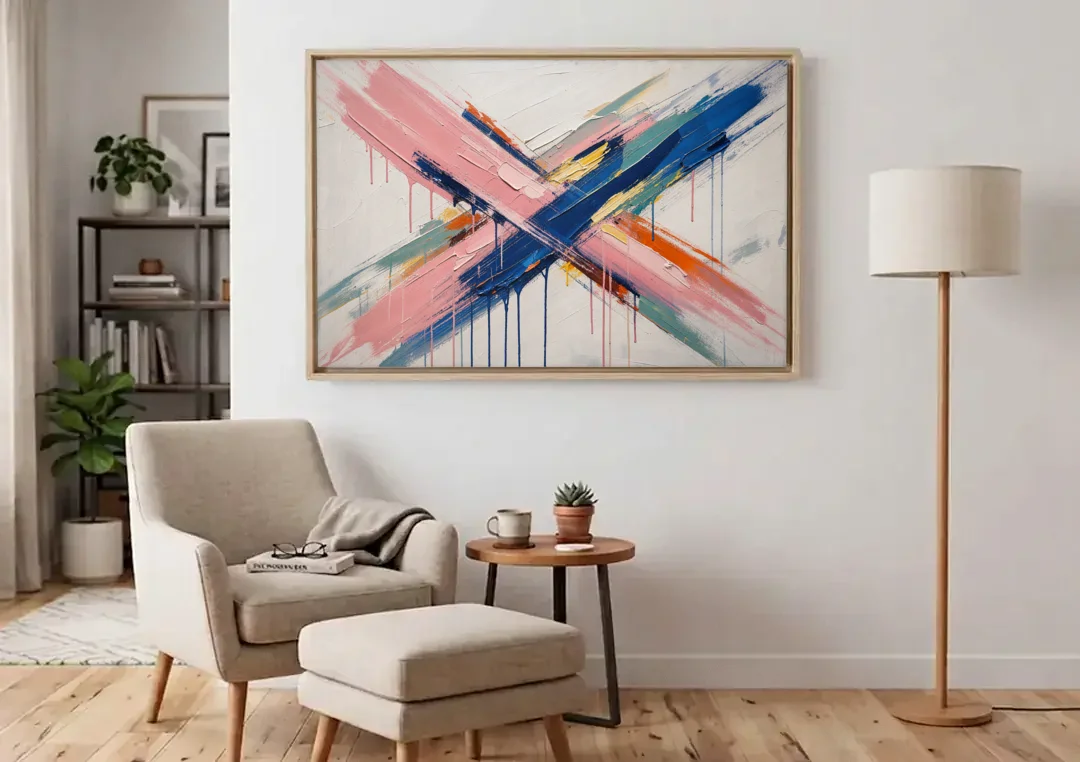 Pink and Blue Abstract Painting Crossed in Cobalt canvas wall art above an armchair in a bright living room