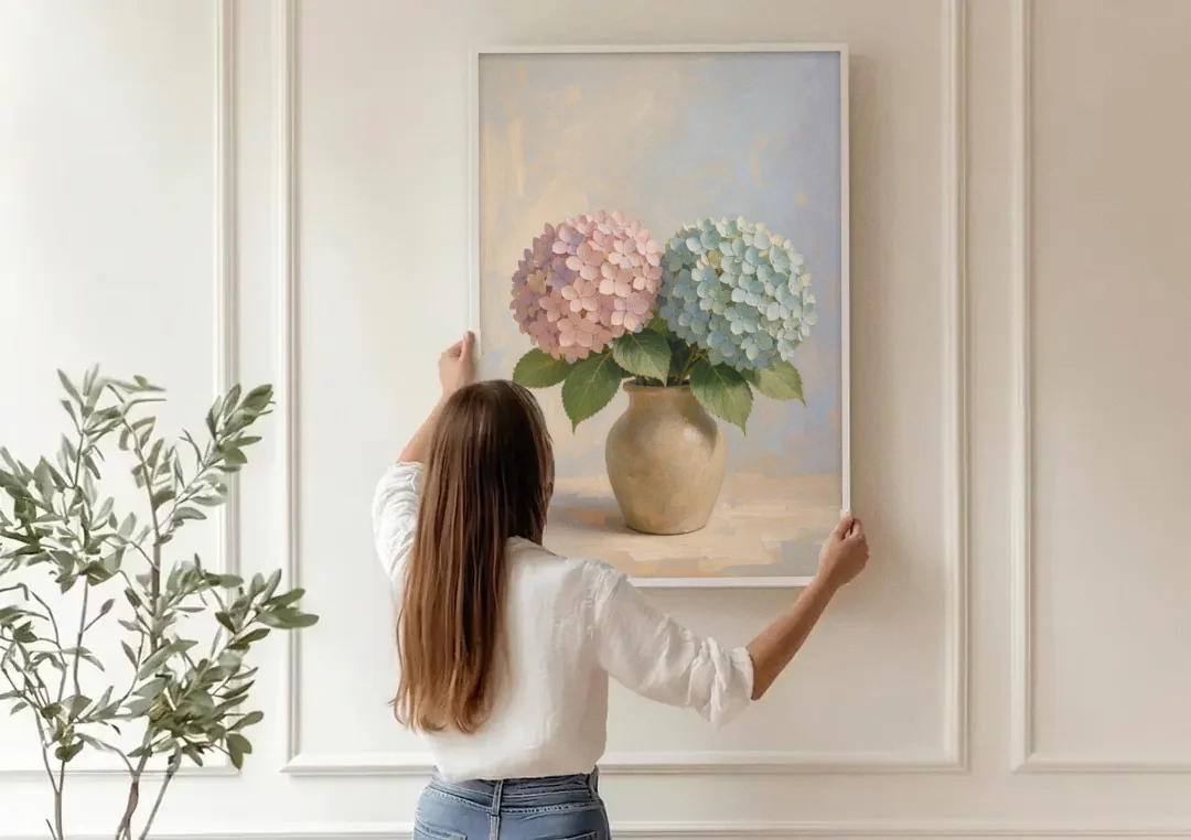 Pink and Blue Hydrangeas in a Sand Vase canvas wall art being hung on a paneled wall