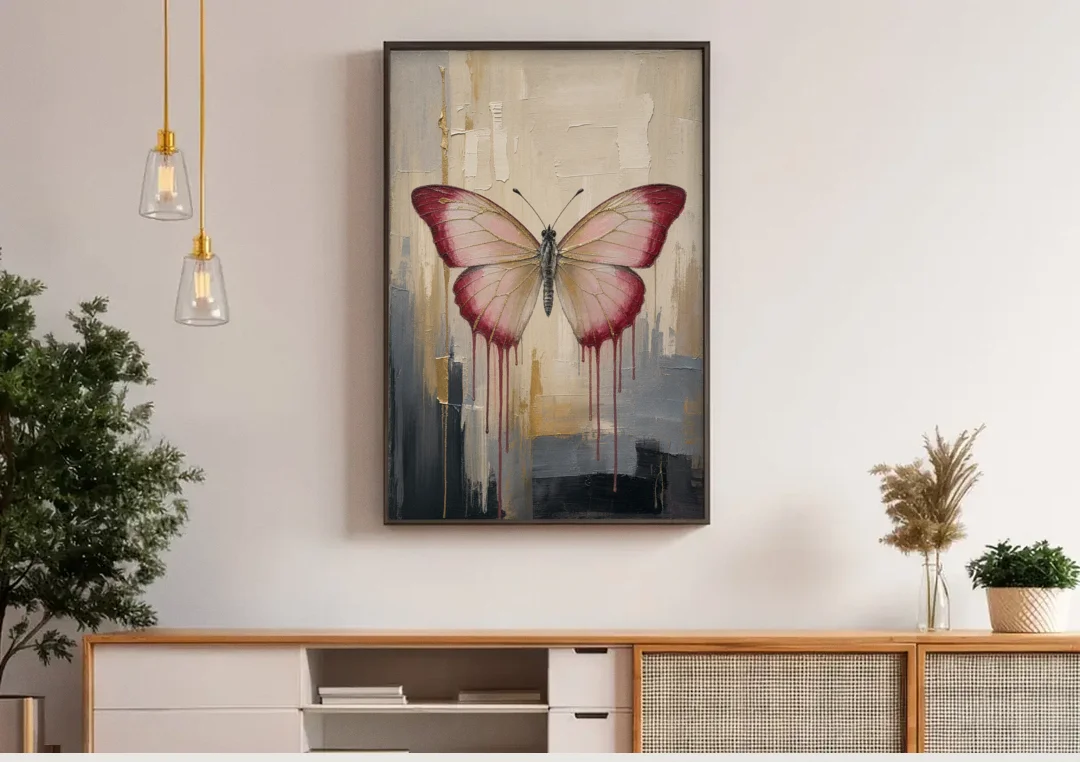 Pink Butterfly with Crimson Drips canvas wall art above a wooden sideboard under pendant lights