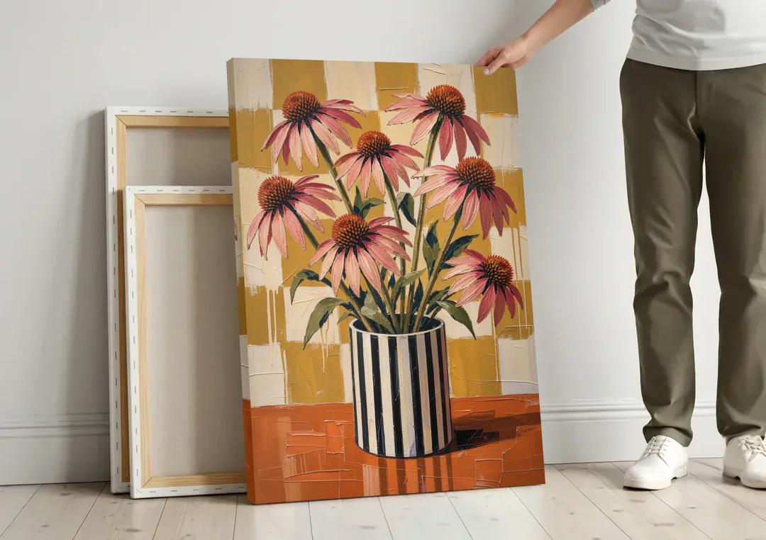 Pink Floral Wall Art of Striped Vase Coneflowers canvas wall art leaning against a wall next to blank canvases