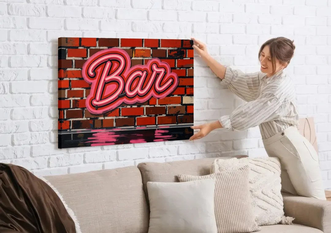 Pink Neon Bar Sign on Red Brick Wall canvas wall art being hung on a white brick wall above a sofa