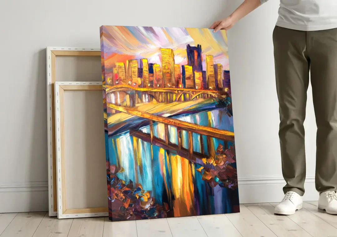 Pittsburgh Downtown Cityscape canvas wall art leaning against a wall next to blank canvases