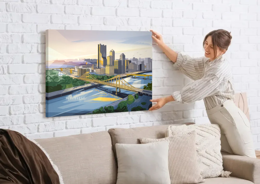 Pittsburgh Golden Triangle View canvas wall art being hung on a white brick wall above a sofa