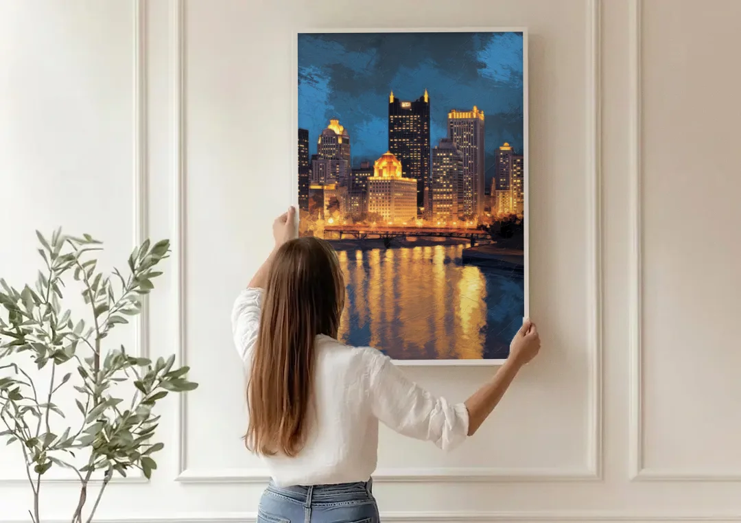 Pittsburgh Nighttime Glow canvas wall art being hung on a paneled wall