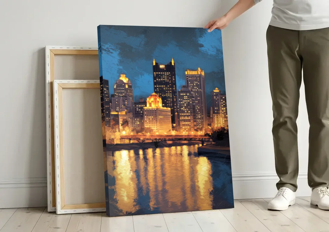 Pittsburgh Nighttime Glow canvas wall art leaning against a wall next to blank canvases