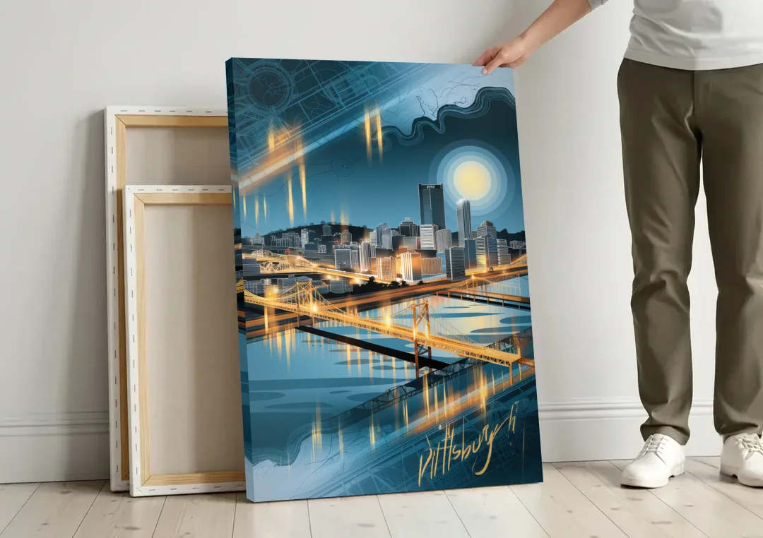 Pittsburgh Skyline and Map canvas wall art leaning against a wall next to blank canvases