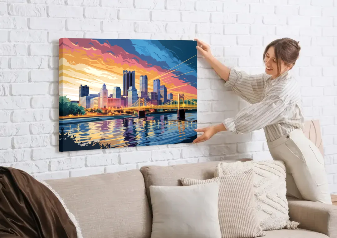 Pittsburgh Skyline At Sunset canvas wall art being hung on a white brick wall above a sofa