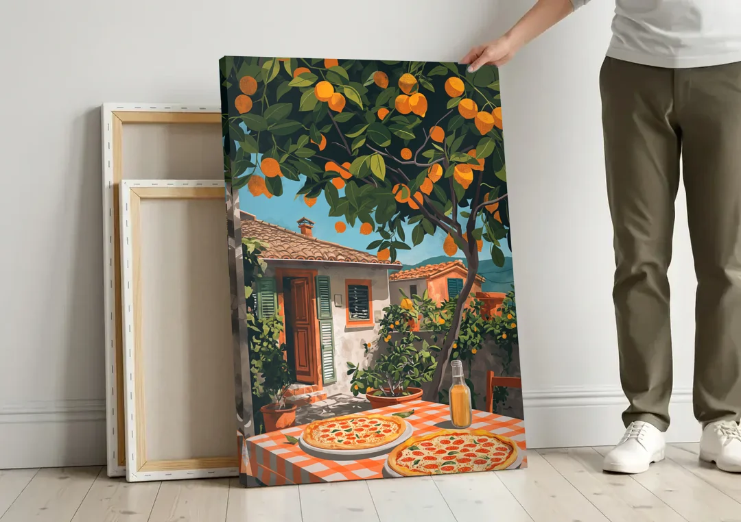 Pizza Painting Under an Orange Tree canvas wall art leaning against a wall next to blank canvases