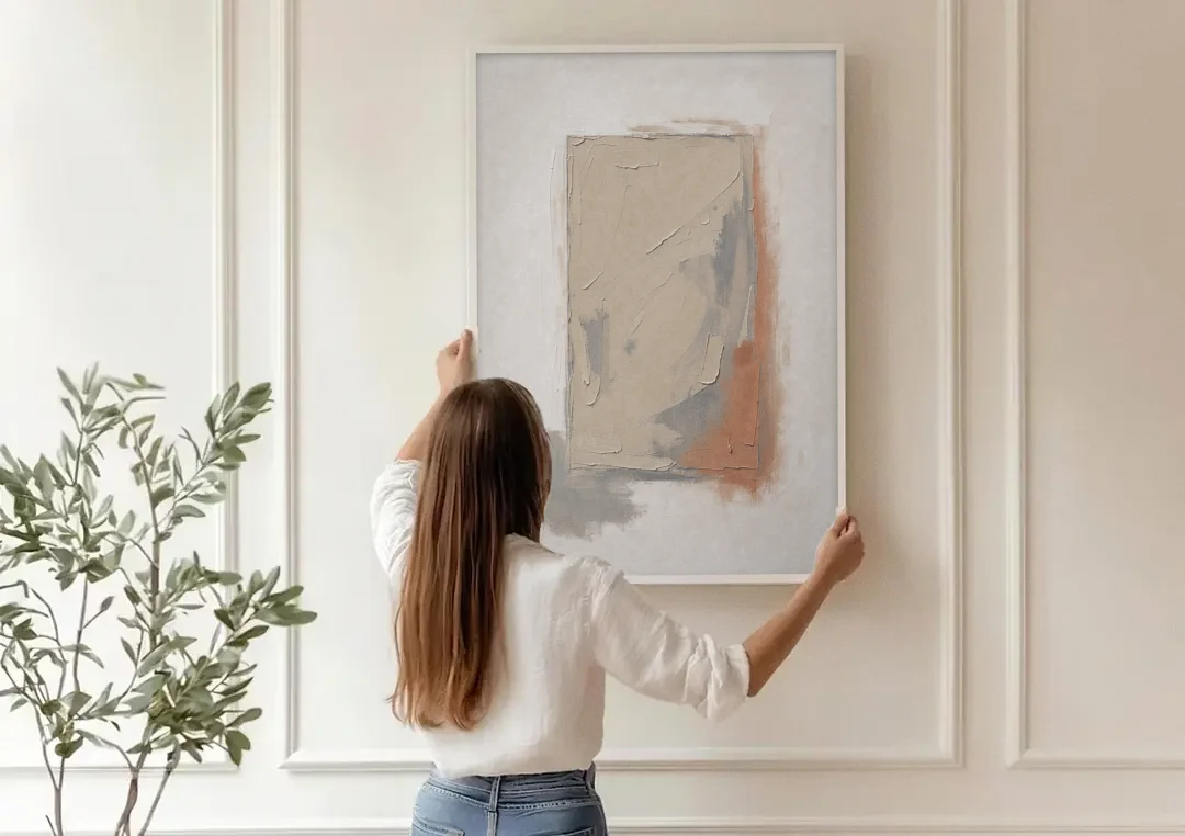 Plaster Texture Wall Art with Terracotta Shadow canvas wall art being hung on a paneled wall