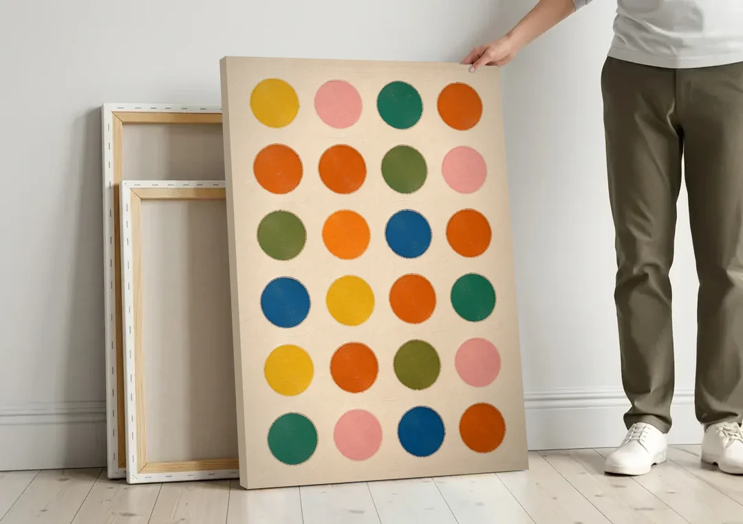 Playroom Wall Art with Twenty-Four Painted Dots canvas wall art leaning against a wall next to blank canvases