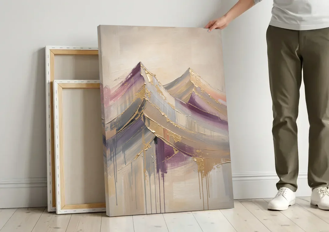 Abstract Plum and Gold Mountain Peaks canvas wall art leaning against a wall next to blank canvases