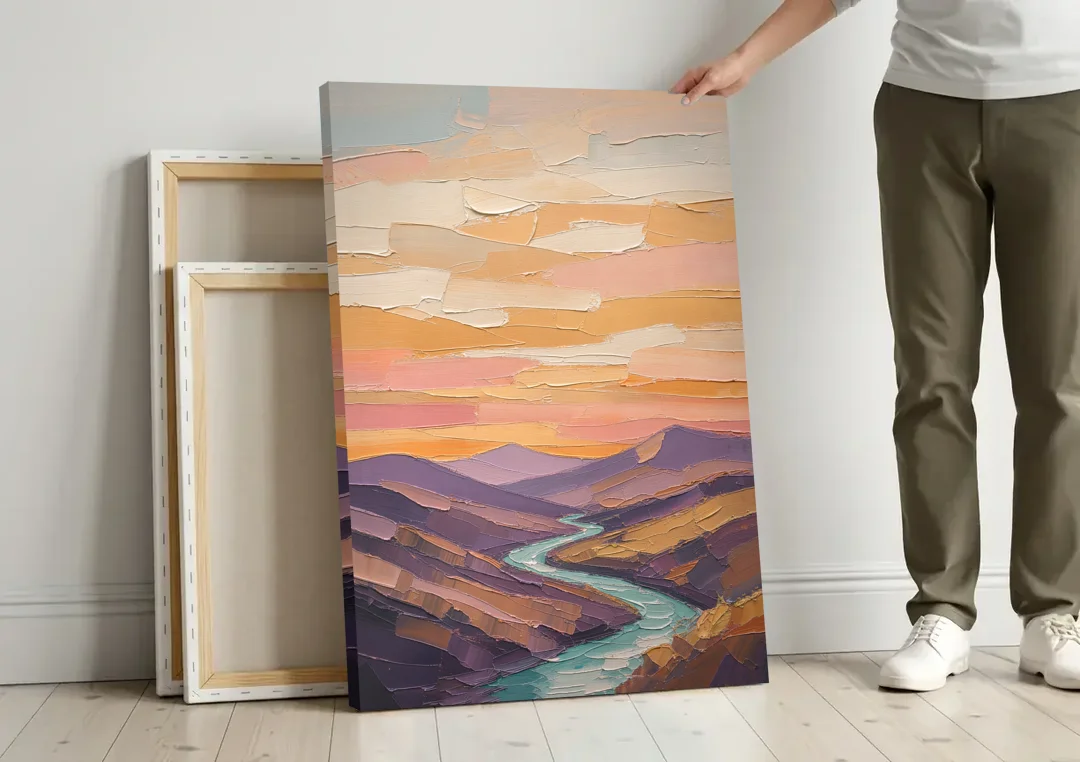 Plum Hills and Teal River at Sunset canvas wall art leaning against a wall next to blank canvases