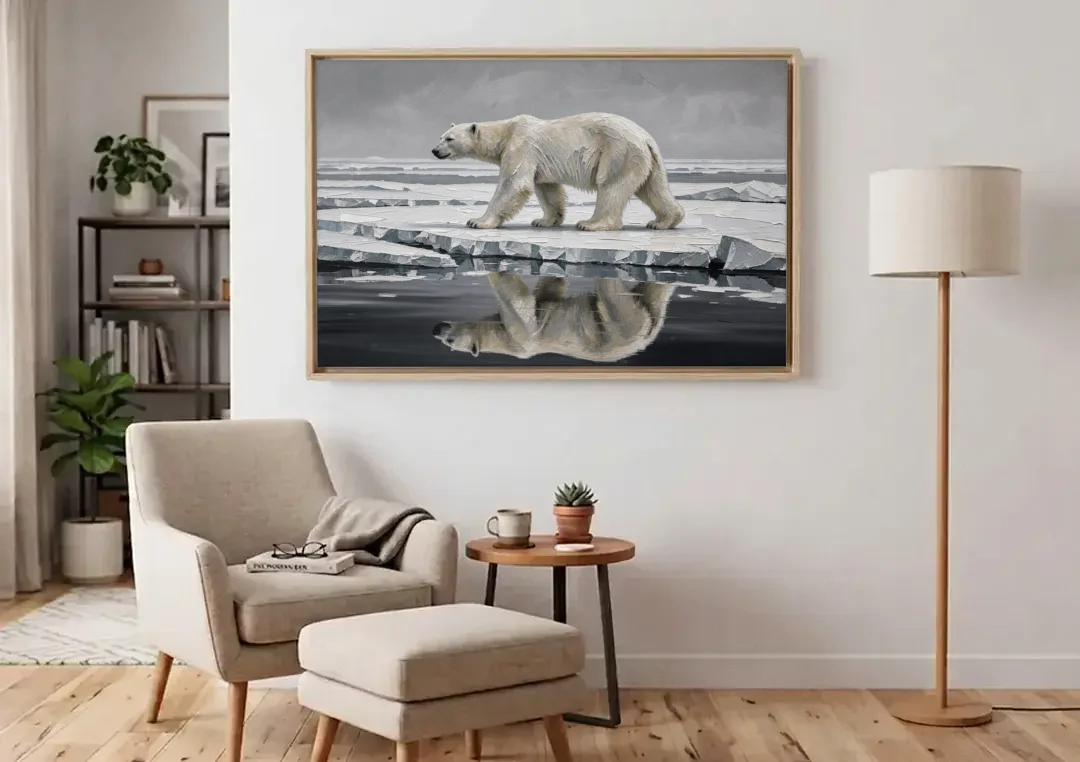 Black and White Polar Bear on Broken Sea Ice canvas wall art above an armchair in a bright living room