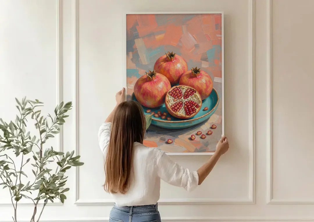 Pomegranates in a Turquoise Bowl for the Kitchen canvas wall art being hung on a paneled wall