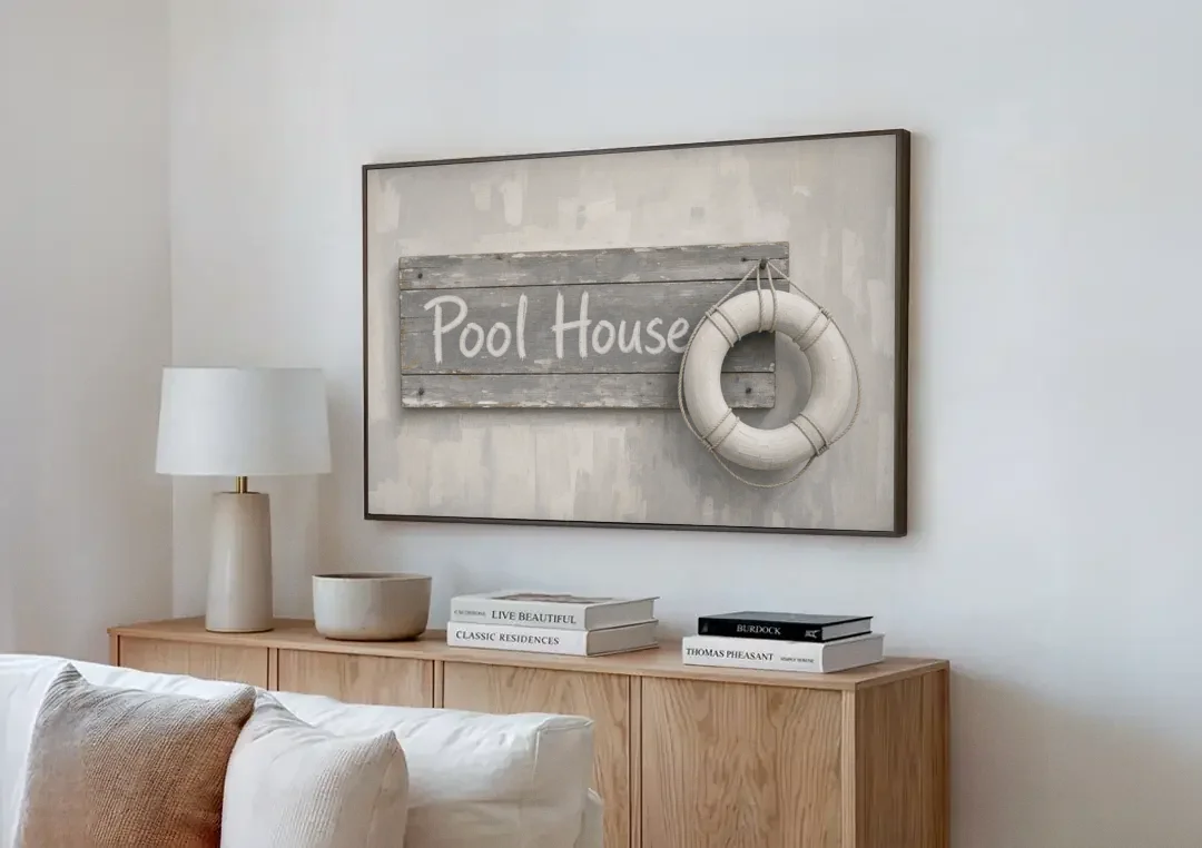 Pool House Sign with White Life Ring canvas wall art above a wooden sideboard next to a sofa
