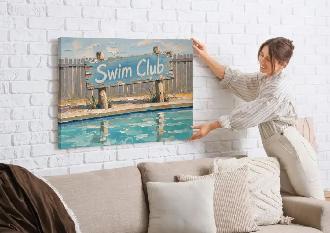 Pool Signs for Backyard Swim Club Board canvas wall art being hung on a white brick wall above a sofa