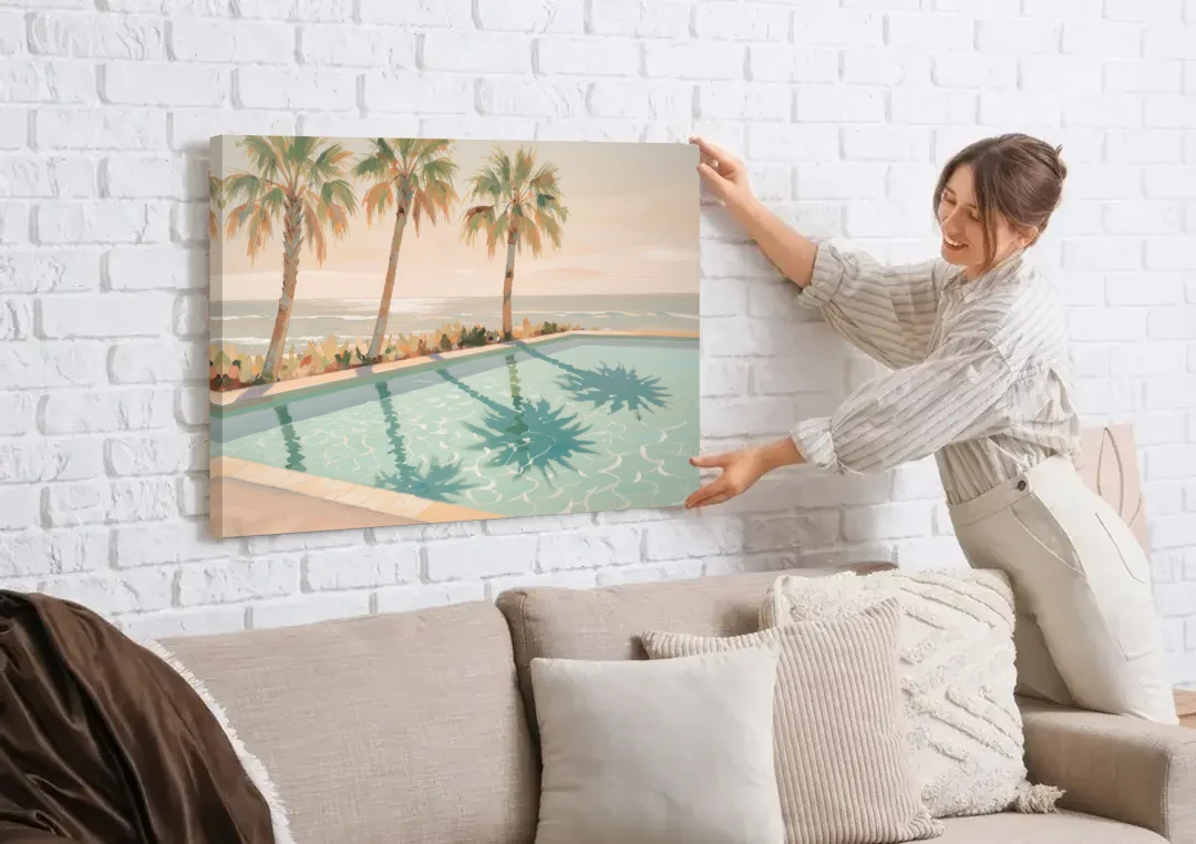 Poolside Art with Three Palm Shadows canvas wall art being hung on a white brick wall above a sofa
