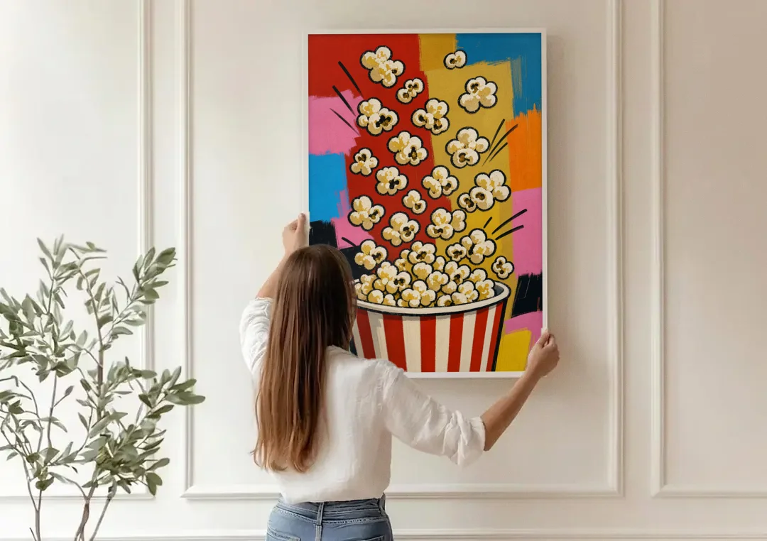 Popcorn Wall Art Bursting from a Striped Bucket canvas wall art being hung on a paneled wall