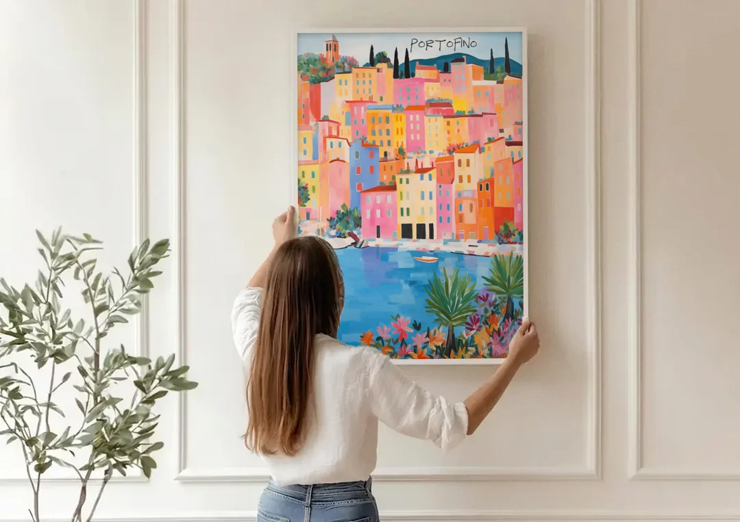Portofino Art of Pastel Harbor Houses canvas wall art being hung on a paneled wall