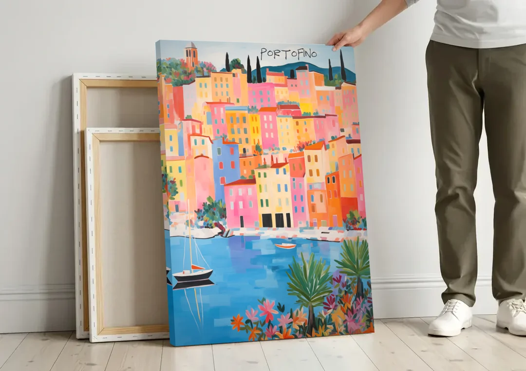 Portofino Art of Pastel Harbor Houses canvas wall art leaning against a wall next to blank canvases