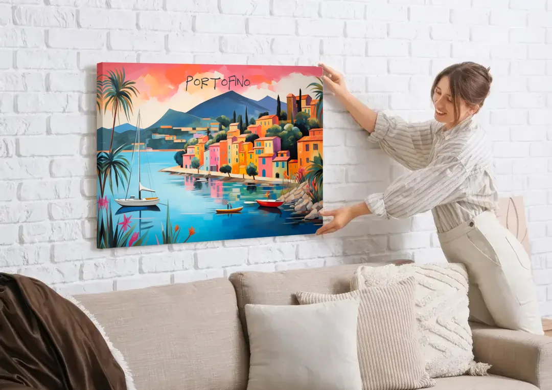 Portofino Painting with a White Sailboat canvas wall art being hung on a white brick wall above a sofa