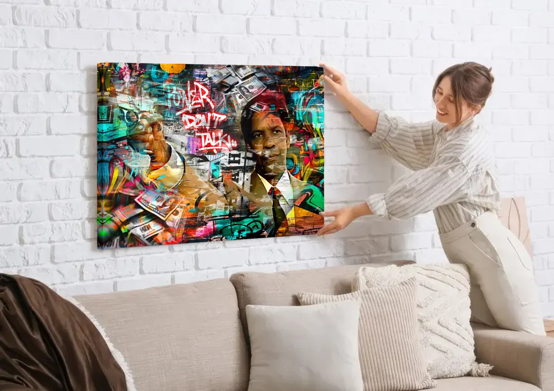 Power Don't Talk canvas wall art being hung on a white brick wall above a sofa