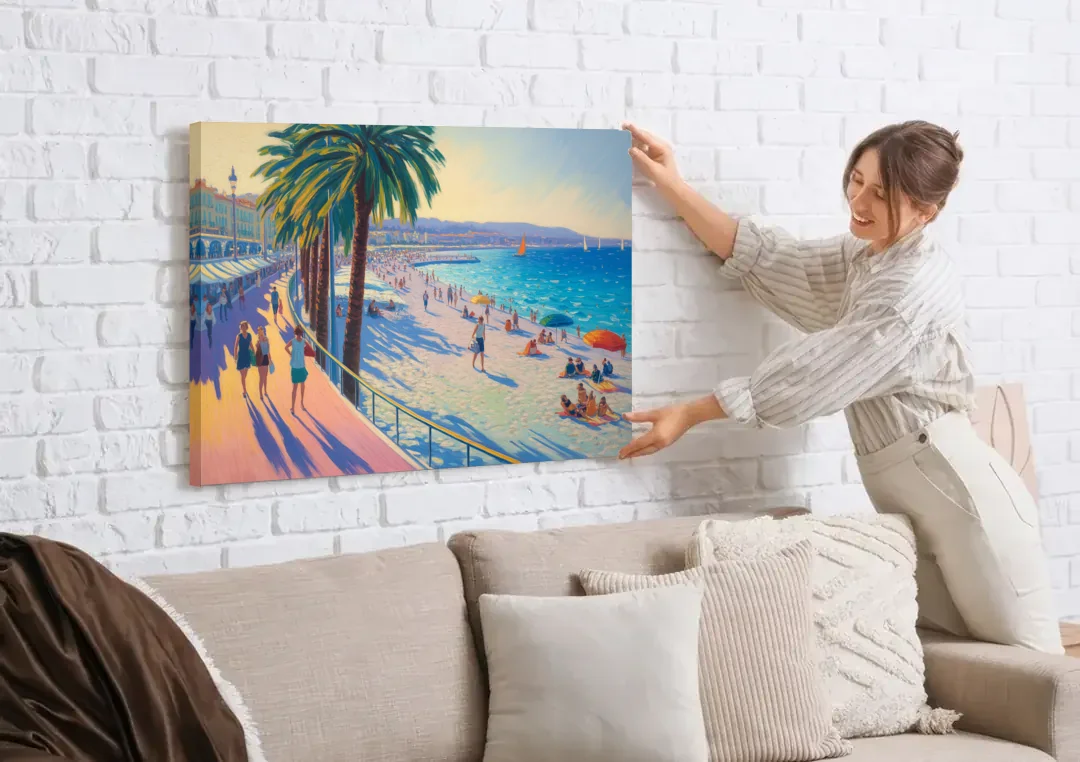 Promenade des Anglais canvas wall art being hung on a white brick wall above a sofa