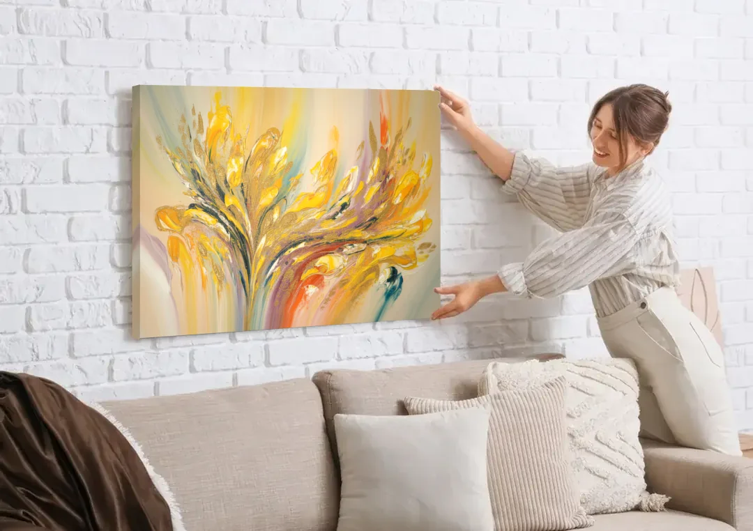 Radiant Flowing Forms Yellow Abstract canvas wall art being hung on a white brick wall above a sofa
