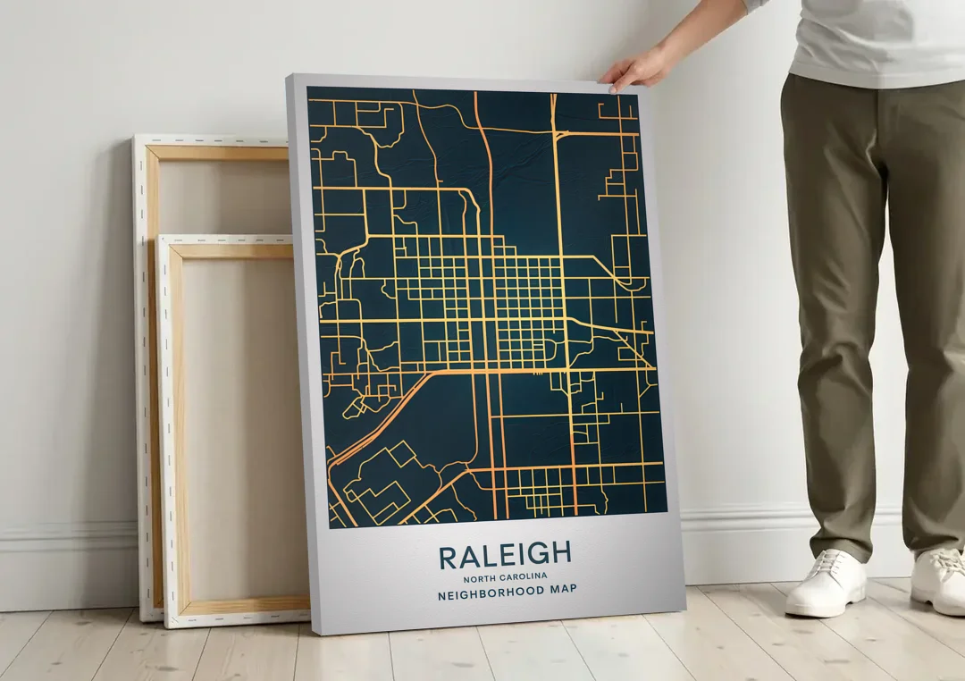 Raleigh Neighborhood Map canvas wall art leaning against a wall next to blank canvases