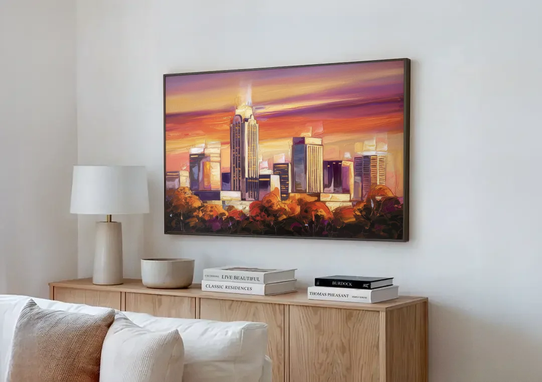 Raleigh Skyline Sunset canvas wall art above a wooden sideboard next to a sofa