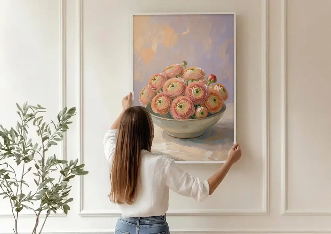 Ranunculus Painting in a Pale Ceramic Bowl canvas wall art being hung on a paneled wall