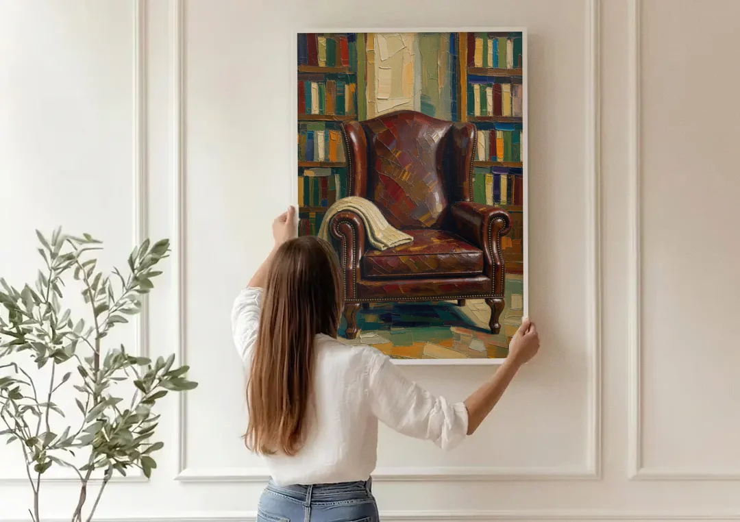 Reading Room Decor with an Oxblood Wingback Chair canvas wall art being hung on a paneled wall
