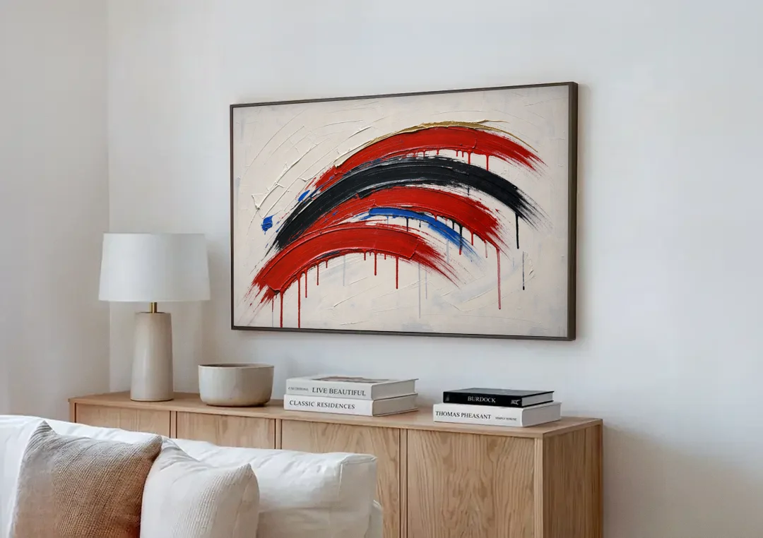 Red and Black Wall Art of Dripping Crescent Arcs canvas wall art above a wooden sideboard next to a sofa
