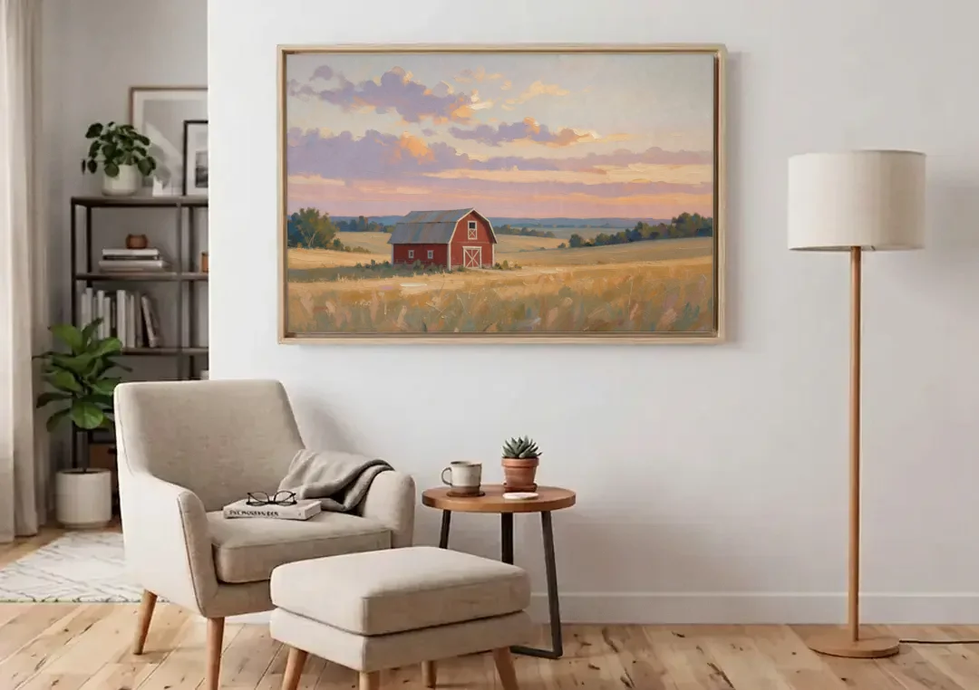 Red Barn Painting at Summer Dusk canvas wall art above an armchair in a bright living room