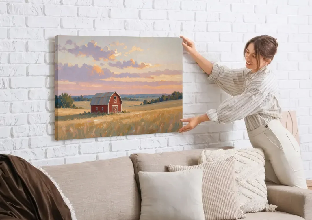 Red Barn Painting at Summer Dusk canvas wall art being hung on a white brick wall above a sofa