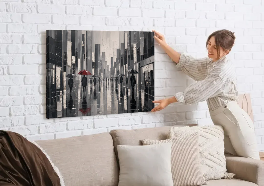 Red Black and White Wall Art of Rainy Streets canvas wall art being hung on a white brick wall above a sofa